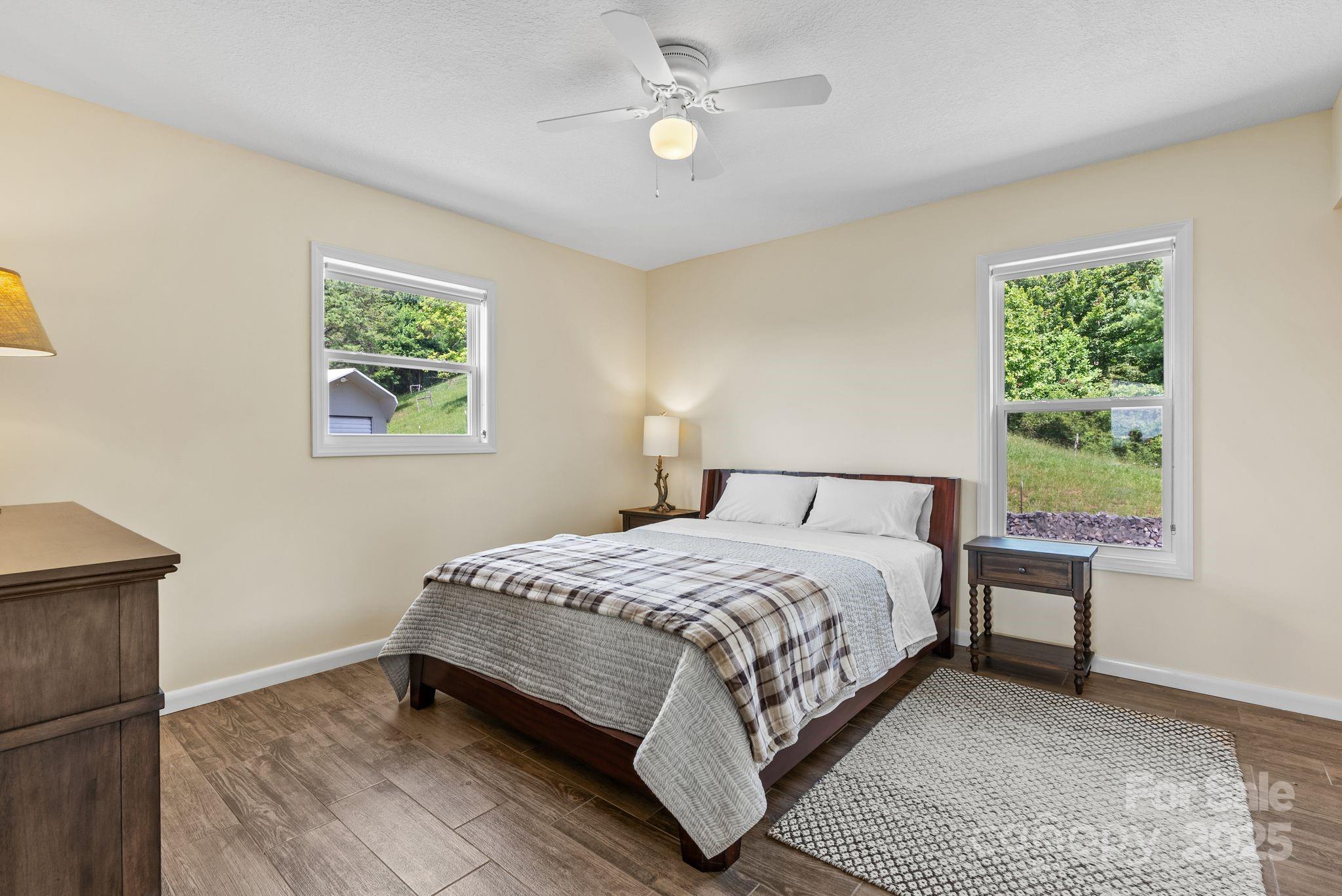 1045 Graham Road Marshall, NC 28753 - Photo 43 of 48 a bedroom with a bed lamp and a window