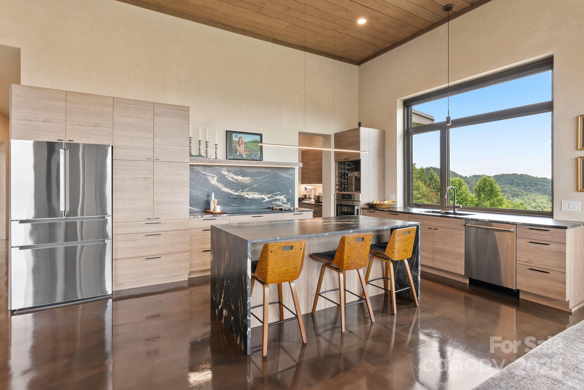1045 Graham Road Marshall, NC 28753 - Photo 7 of 48 a kitchen with stainless steel appliances granite countertop a table chairs and a refrigerator