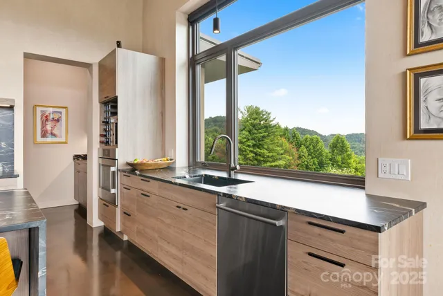a kitchen with a sink and a large window