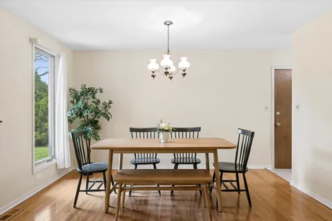 a view of a dining room with furniture window and wooden floor