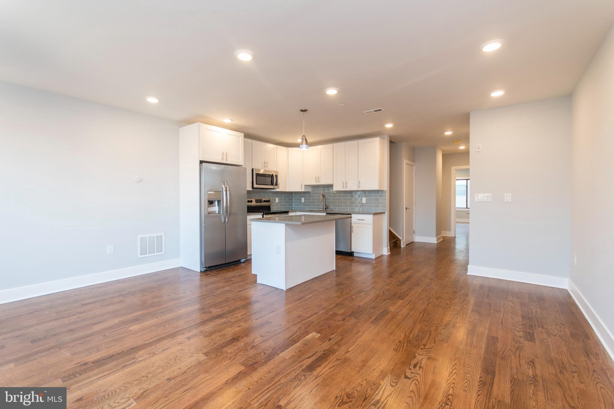 a view of kitchen view wooden cabinets and stainless steel appliances