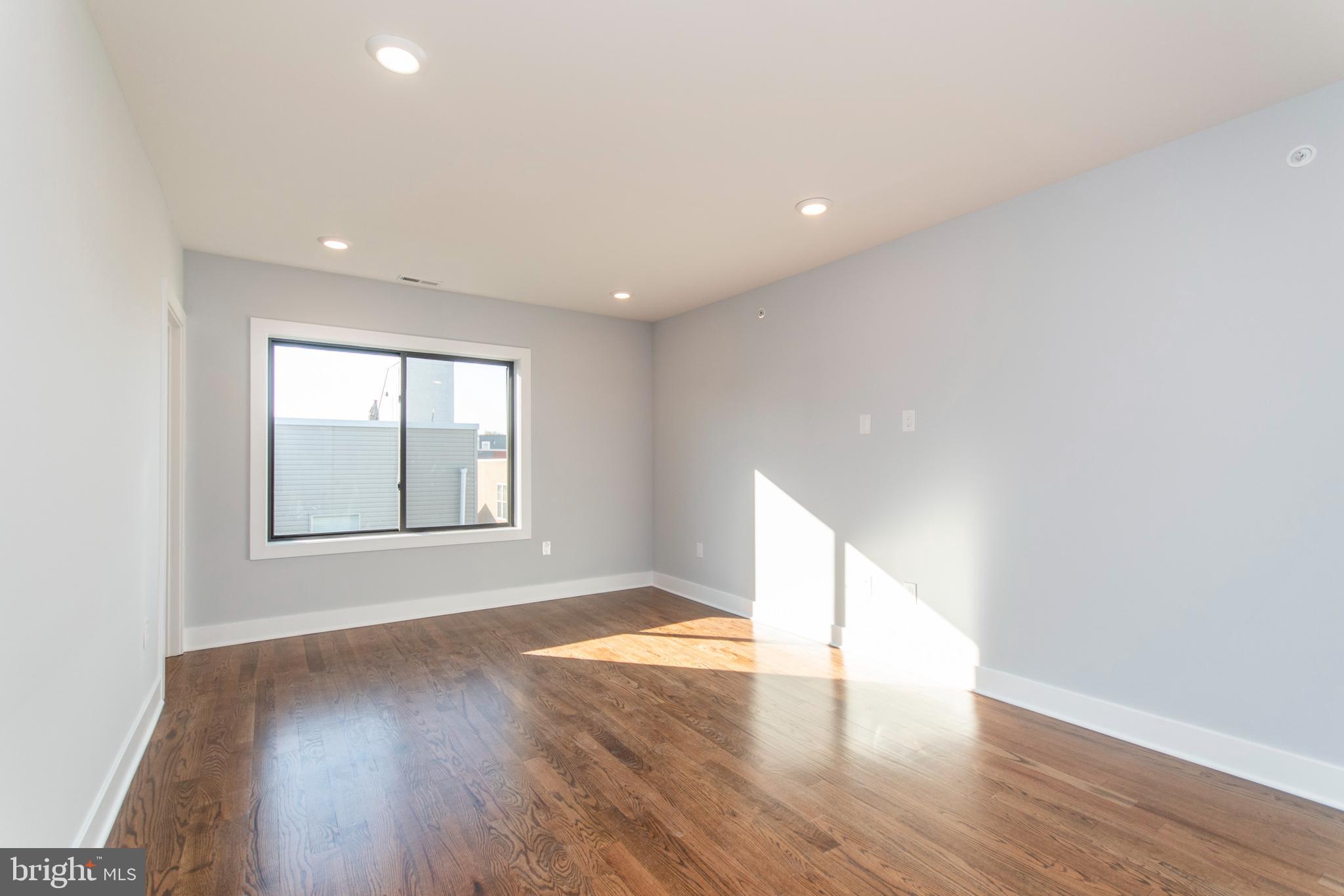812 North Uber Street, Unit 6 Philadelphia, PA 19130 - Photo 11 of 25 a view of an empty room with wooden floor and a window