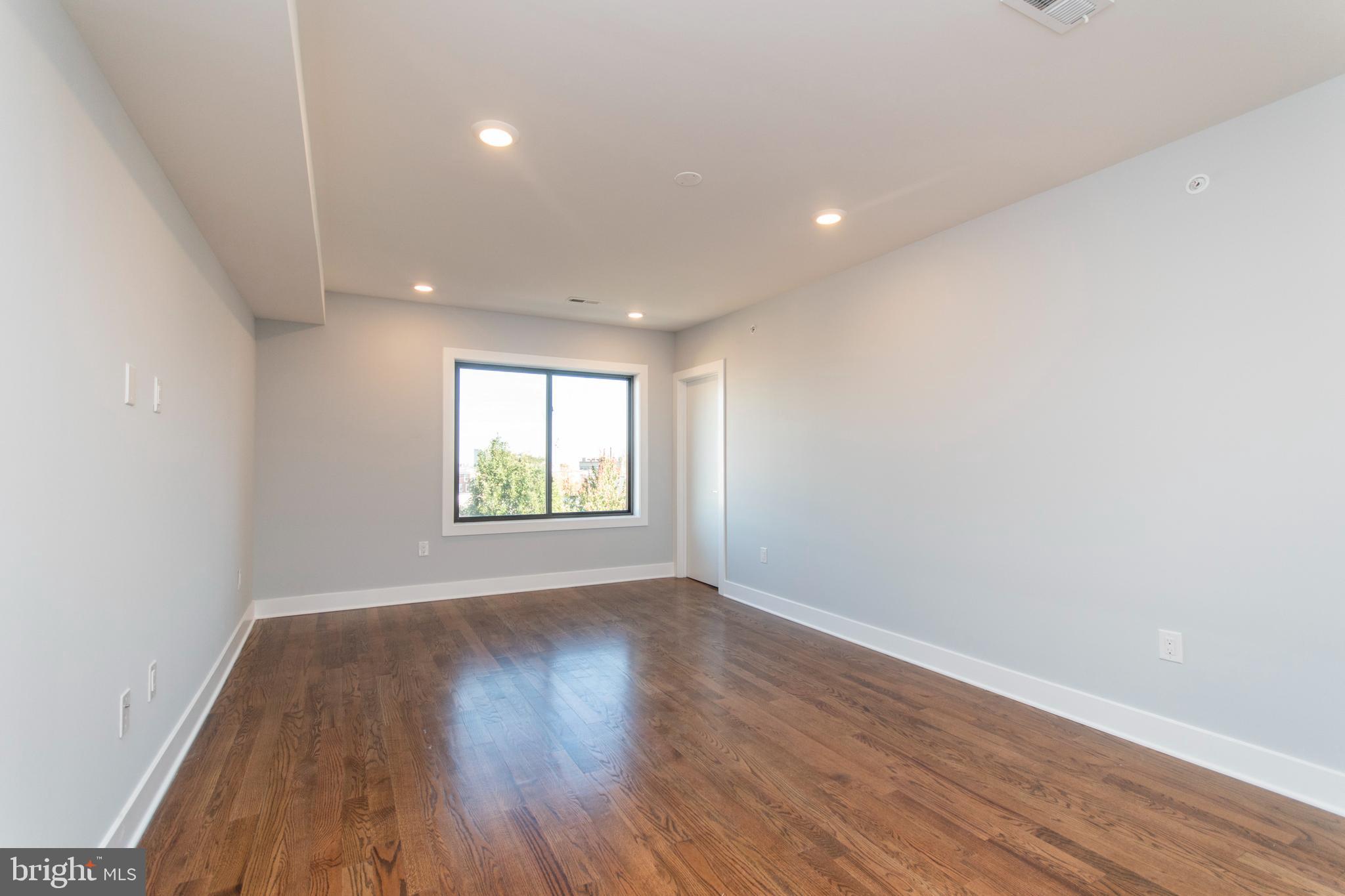 812 North Uber Street, Unit 6 Philadelphia, PA 19130 - Photo 14 of 25 a view of an empty room with wooden floor and a window