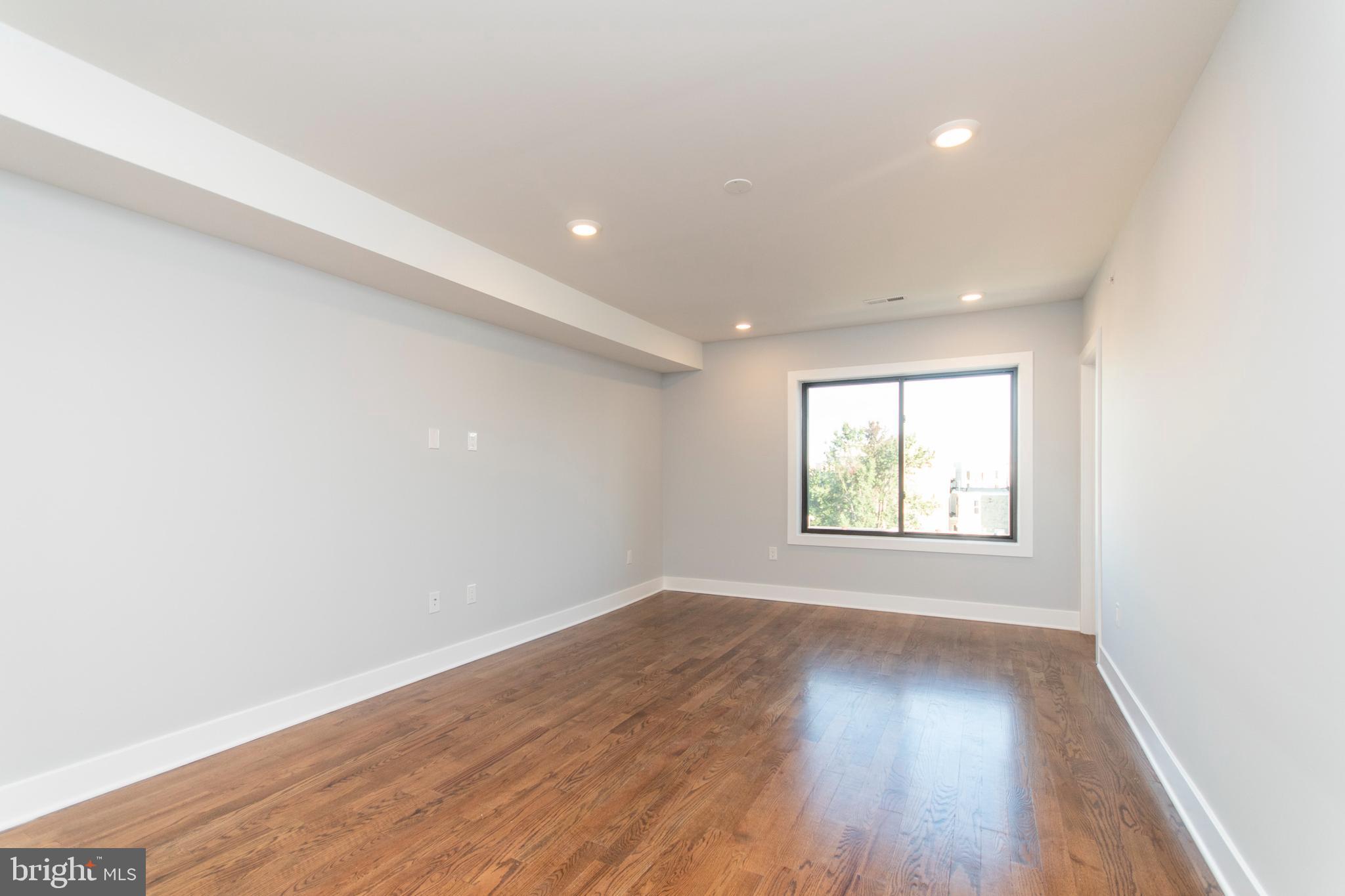 812 North Uber Street, Unit 6 Philadelphia, PA 19130 - Photo 15 of 25 an empty room with wooden floor and windows