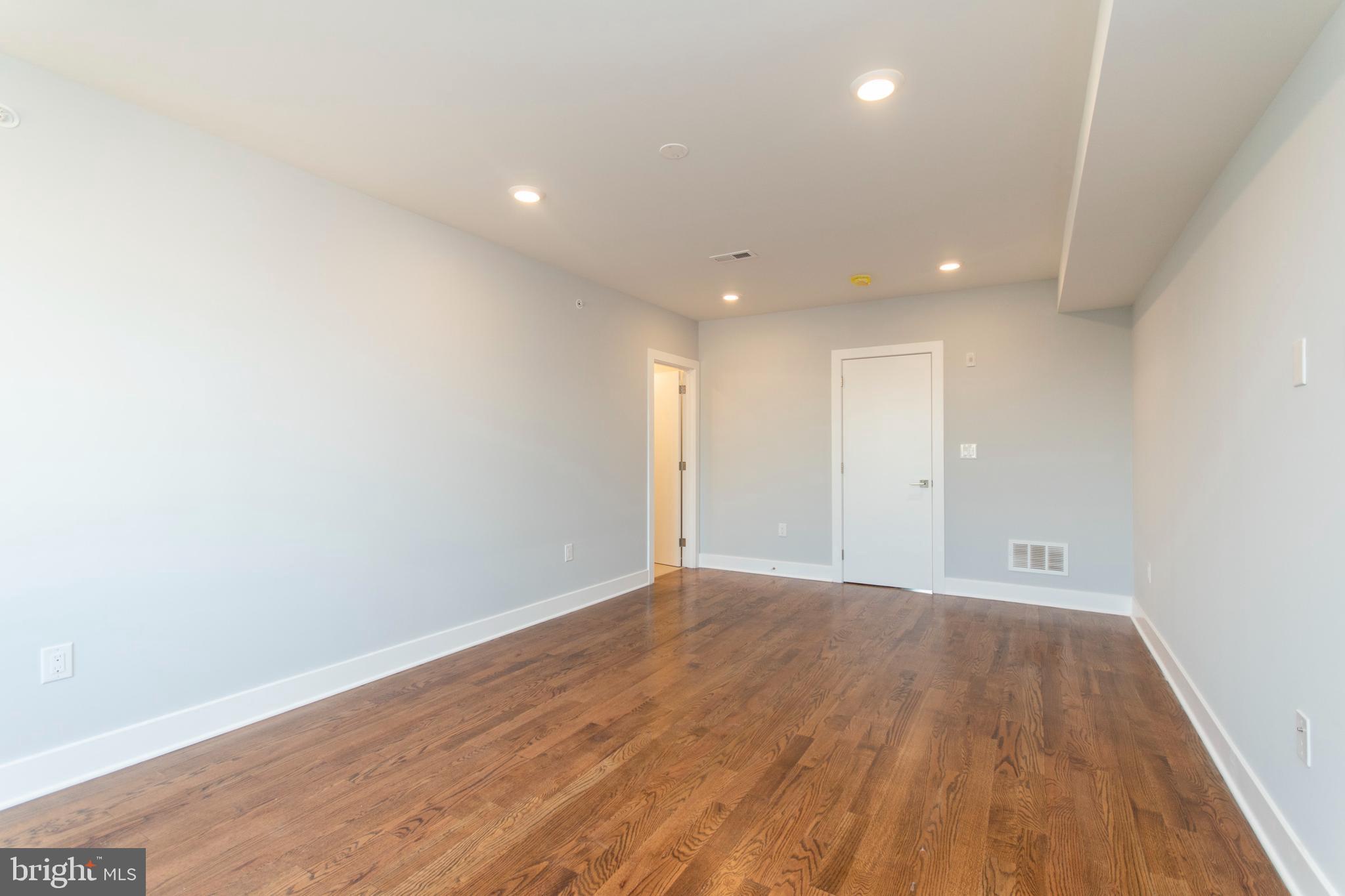 812 North Uber Street, Unit 6 Philadelphia, PA 19130 - Photo 16 of 25 a view of an empty room with wooden floor