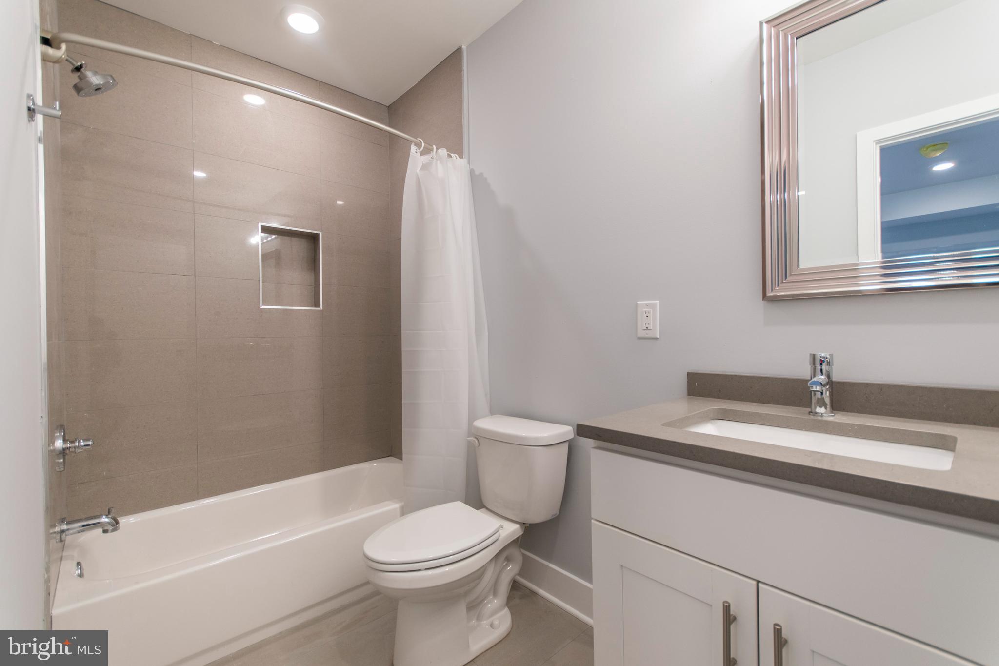 812 North Uber Street, Unit 6 Philadelphia, PA 19130 - Photo 19 of 25 a bathroom with a granite countertop sink toilet and shower