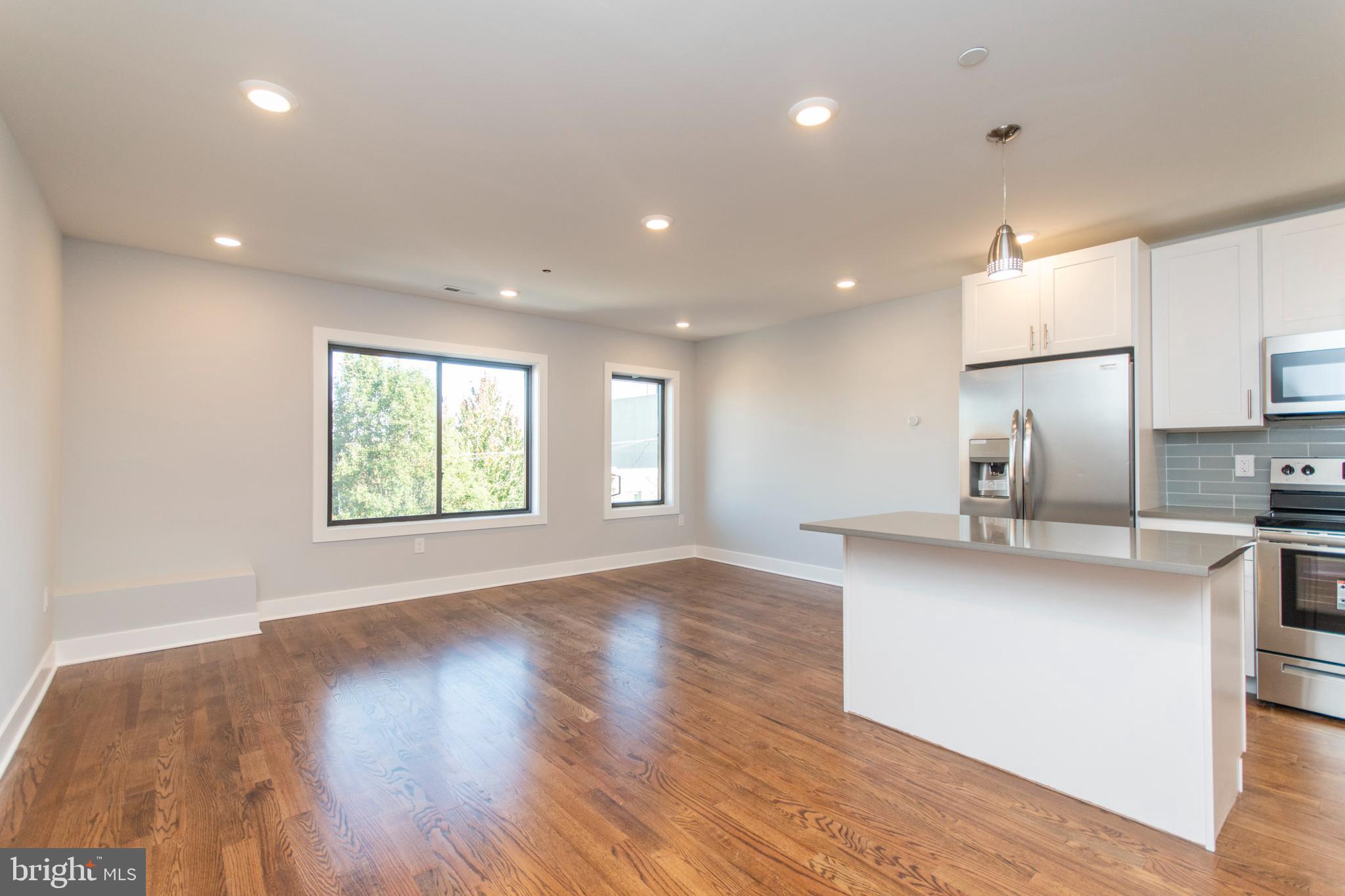 812 North Uber Street, Unit 6 Philadelphia, PA 19130 - Photo 2 of 25 a view of kitchen with wooden floor electronic appliances and window