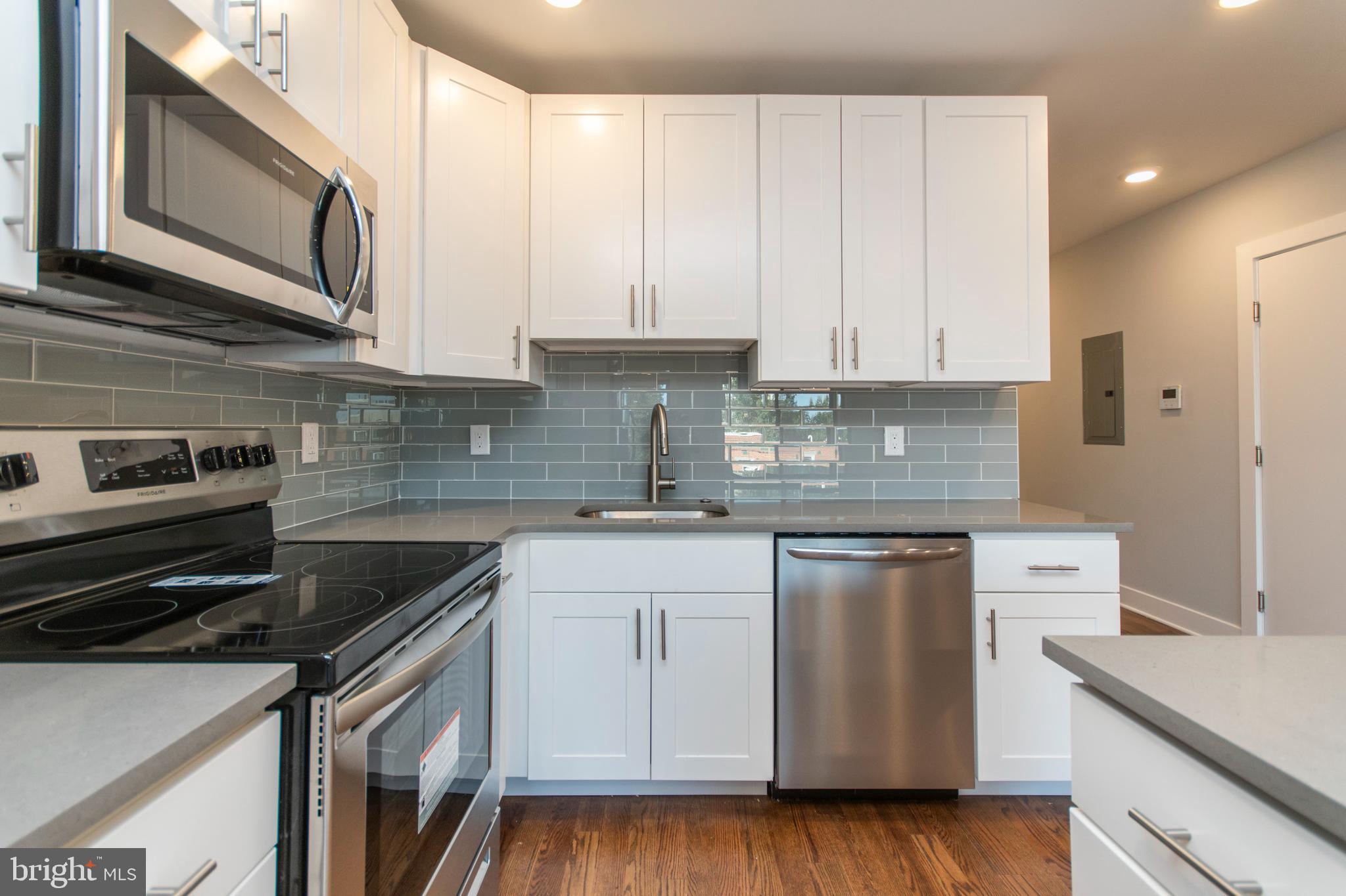 812 North Uber Street, Unit 6 Philadelphia, PA 19130 - Photo 5 of 25 a kitchen with stainless steel appliances granite countertop a sink stove and cabinets