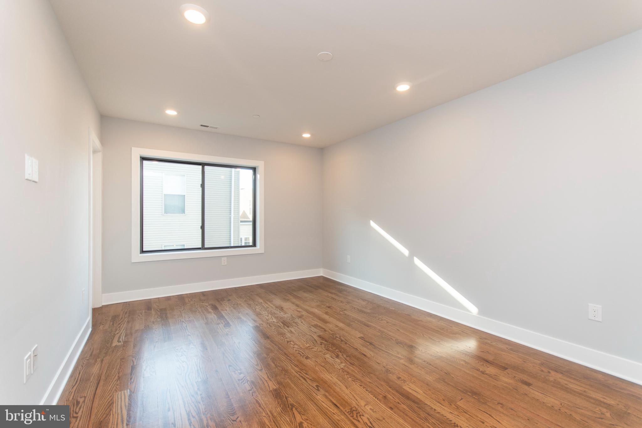 812 North Uber Street, Unit 6 Philadelphia, PA 19130 - Photo 7 of 25 a view of an empty room with wooden floor and a window