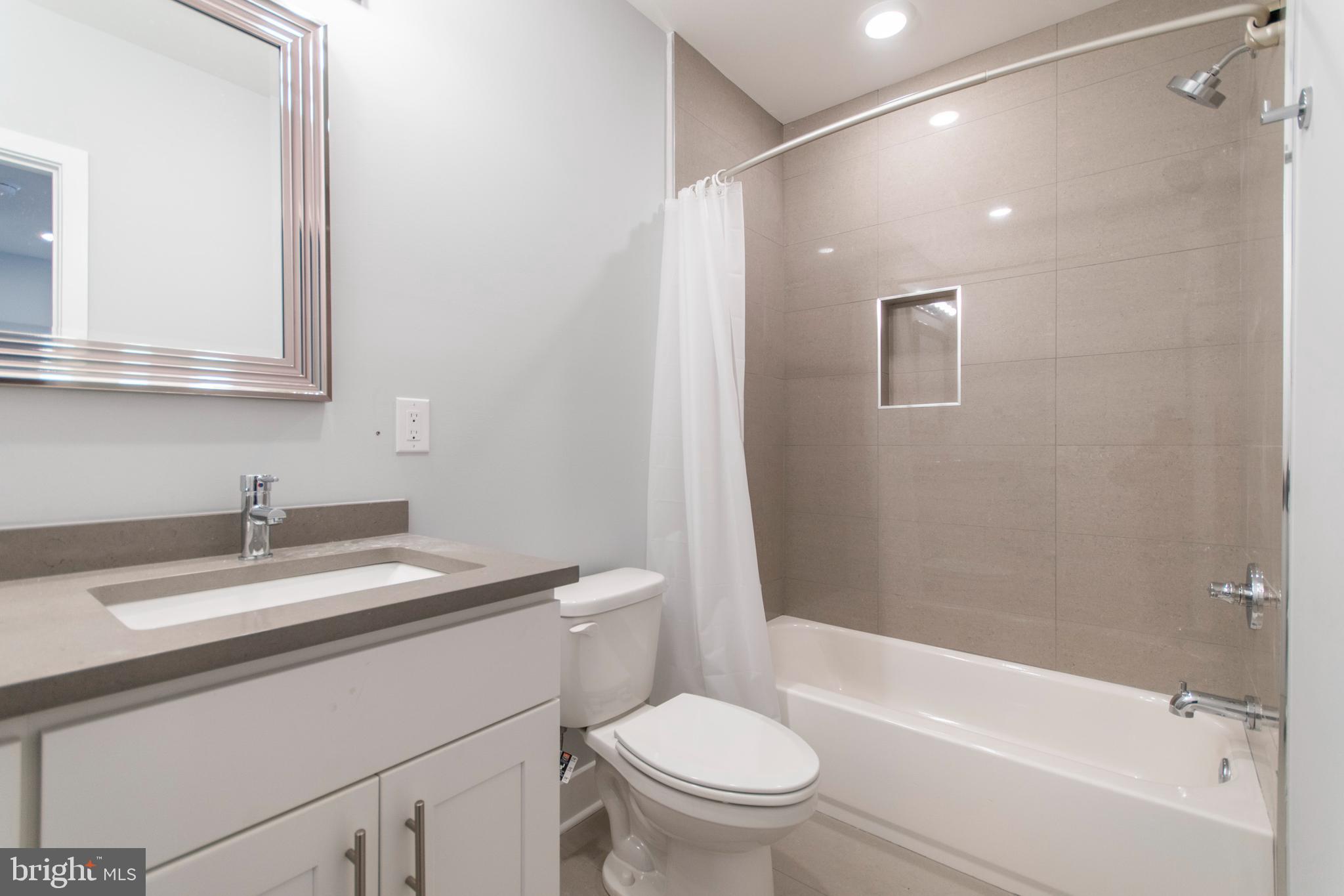 812 North Uber Street, Unit 6 Philadelphia, PA 19130 - Photo 9 of 25 a bathroom with a sink a toilet and a bathtub