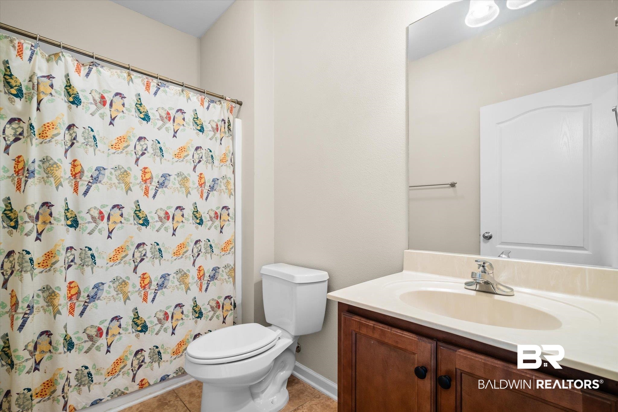 10251 Fionn Loop Daphne, AL 36526 - Photo 16 of 28 Bathroom with tile patterned flooring, vanity, toilet, and a shower with shower curtain