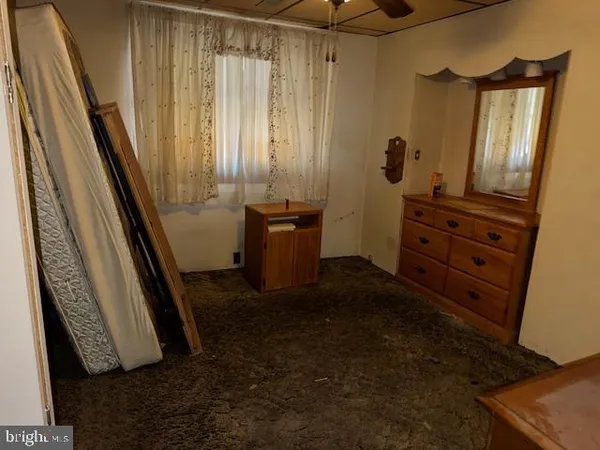 a view of a closet with wooden floor