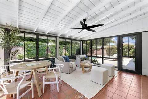 a view of a chair and table in the backyard