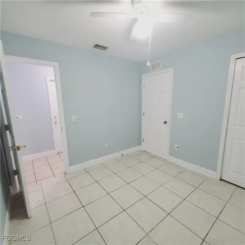 an empty room with white walls and tiles