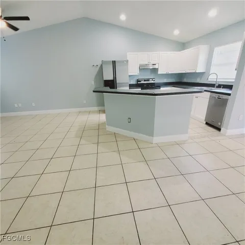 a kitchen with stainless steel appliances a sink stove and cabinets