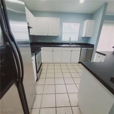 a view of a kitchen with a sink and cabinets