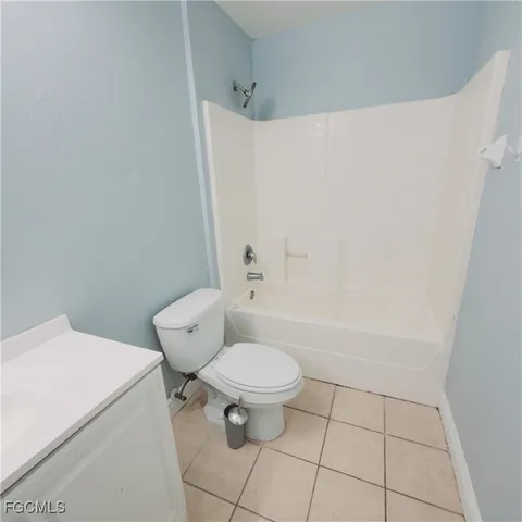 a white toilet sitting next to a white tub