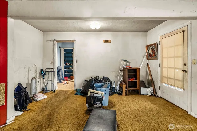 a view of a livingroom with workspace and a window