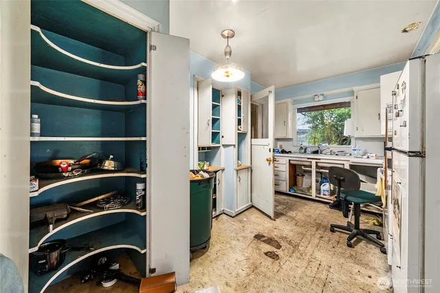 a kitchen with a stove a sink and a refrigerator