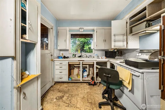 a kitchen with a stove a sink and a refrigerator