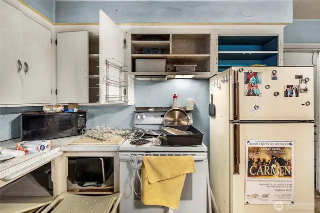 a kitchen with a stove a refrigerator and a stove