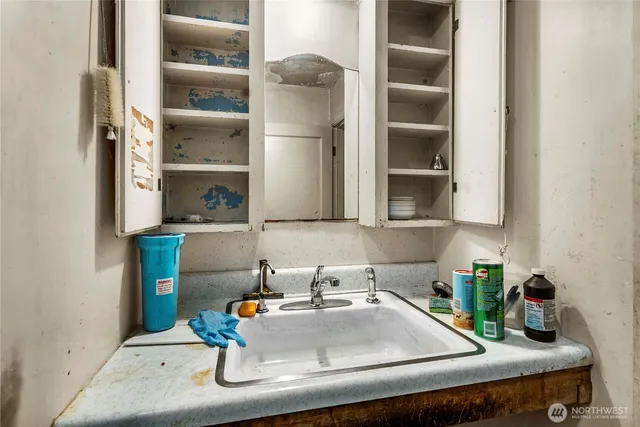 a view of staircase with a chair and a potted plant next to a window