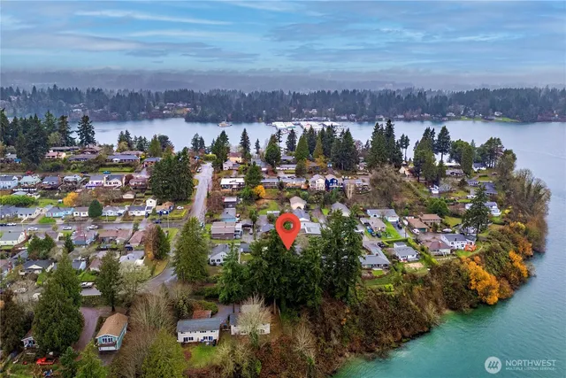 an aerial view of a house with garden space and a yard