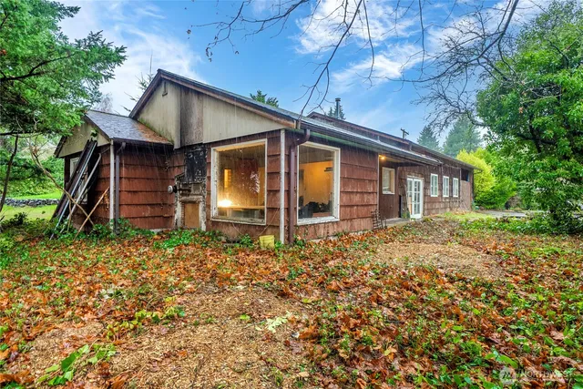 a house with green field in front of it