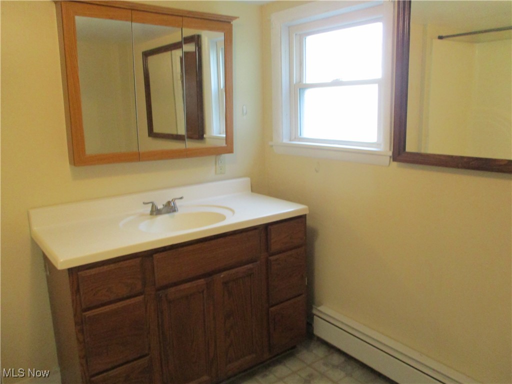 15401 A Madison Road Middlefield, OH 44062 - Photo 9 of 17 Bathroom with baseboard heating and vanity