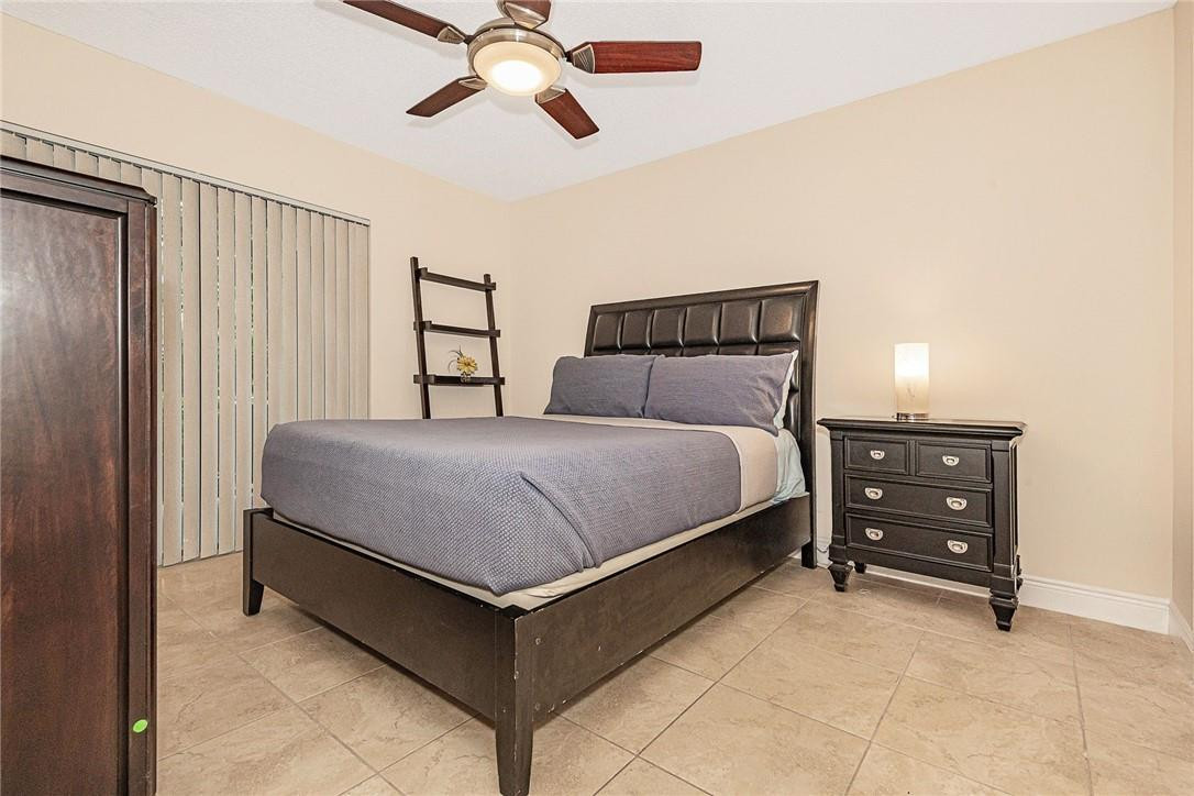 620 South Park Road, Unit 213 Hollywood, FL 33021 - Photo 14 of 28 a bedroom with a bed and a chandelier