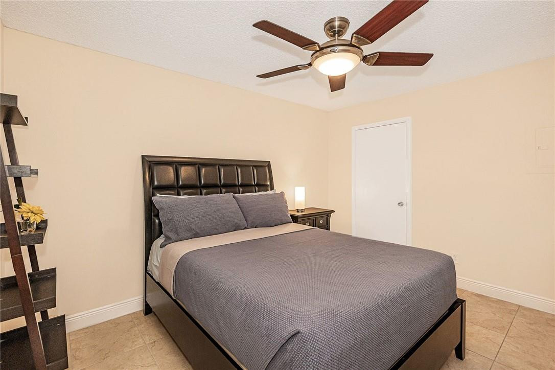 620 South Park Road, Unit 213 Hollywood, FL 33021 - Photo 16 of 28 a bedroom with a bed and a ceiling fan