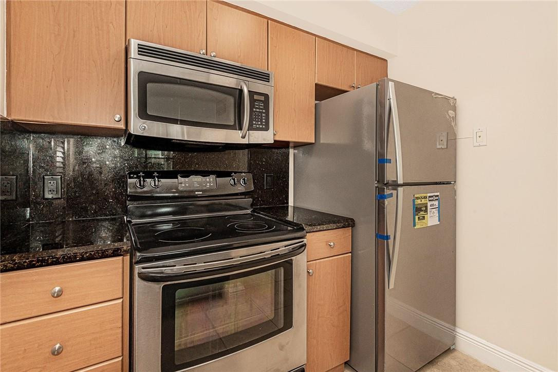 620 South Park Road, Unit 213 Hollywood, FL 33021 - Photo 3 of 28 a kitchen with granite countertop cabinets and steel stainless steel appliances