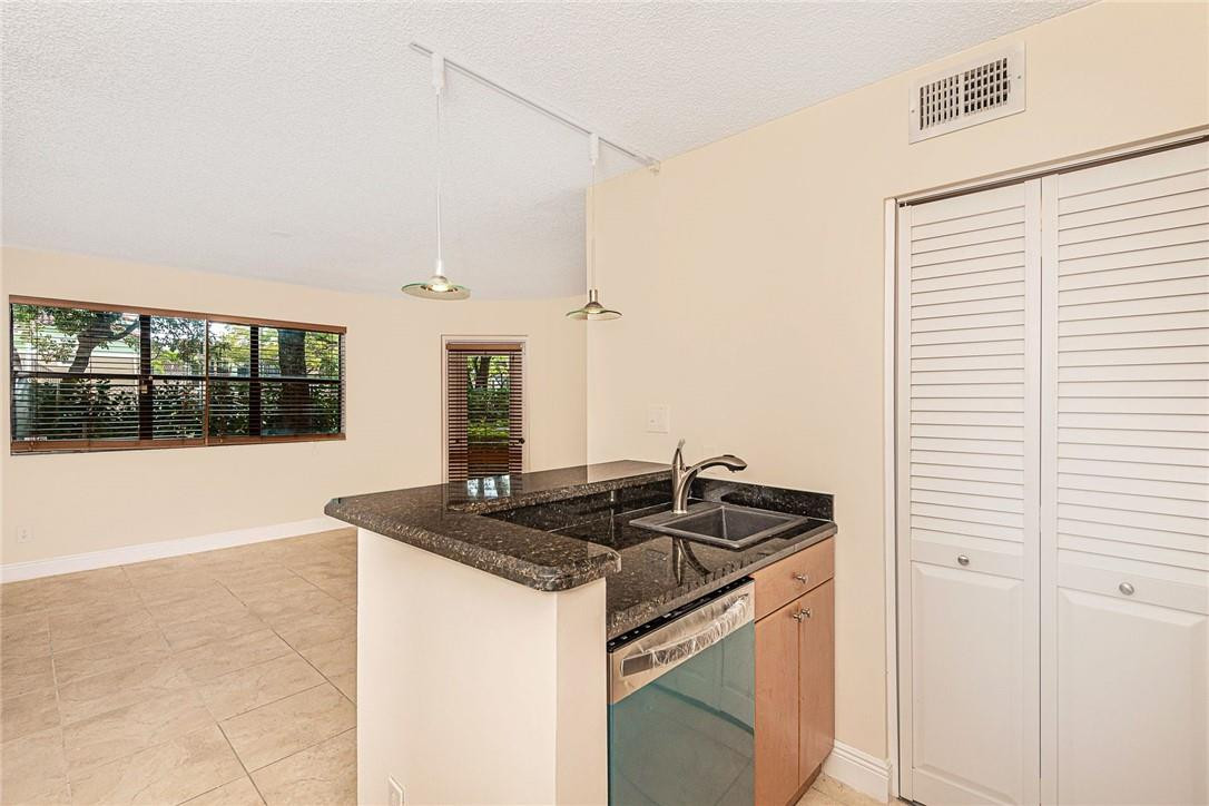 620 South Park Road, Unit 213 Hollywood, FL 33021 - Photo 6 of 28 a kitchen that has a sink and a stove