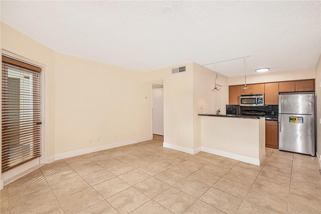 620 South Park Road, Unit 213 Hollywood, FL 33021 - Photo 8 of 28 a view of kitchen with stainless steel appliances a refrigerator and a stove top oven