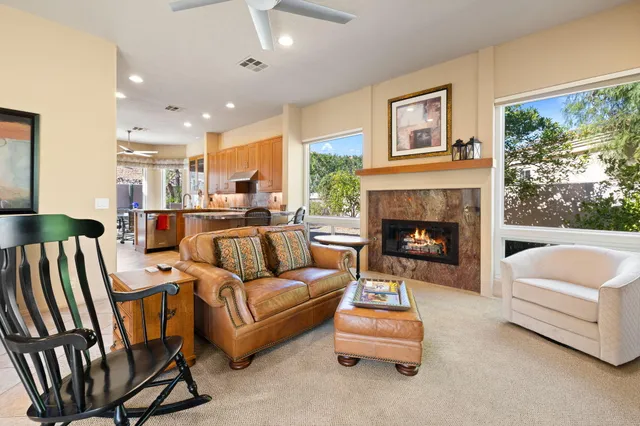 a kitchen with stainless steel appliances kitchen island granite countertop a refrigerator and a sink