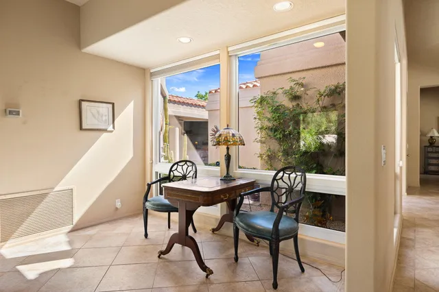 a kitchen with stainless steel appliances kitchen island granite countertop a refrigerator a stove and a sink with granite countertops