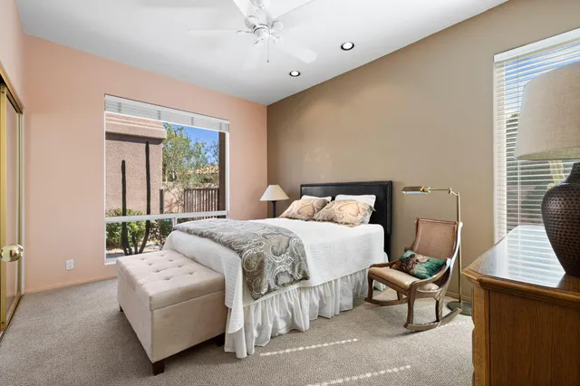 a roof deck with table and chairs and potted plants