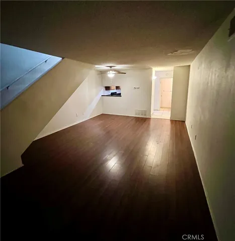 a view of a room with wooden floor