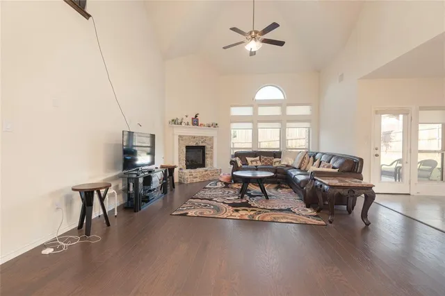 a living room with furniture a fireplace and a chandelier