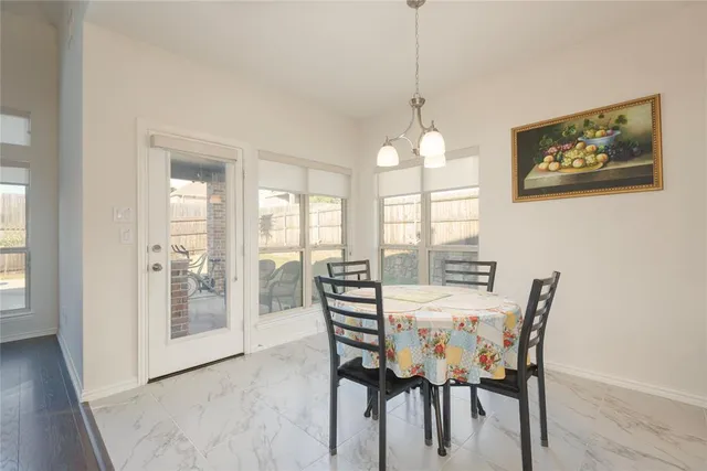 a view of a dining room with furniture wooden floor and a chandelier
