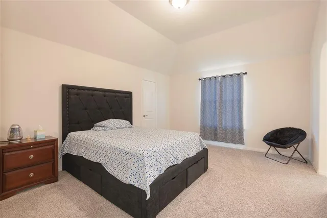 a bedroom with a bed and window