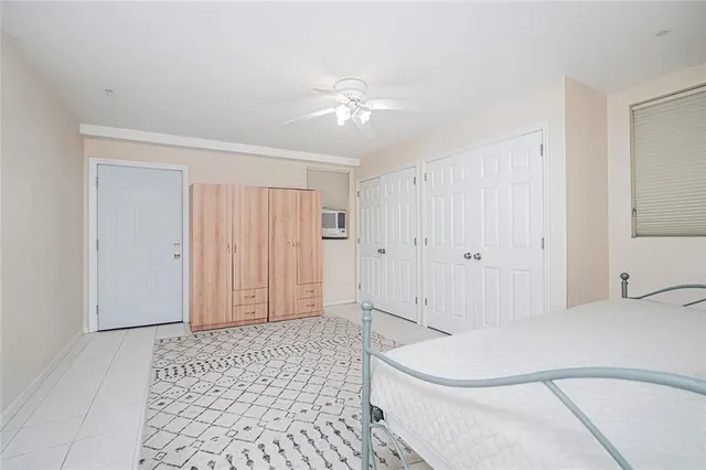 a spacious bedroom with a bed and a chandelier