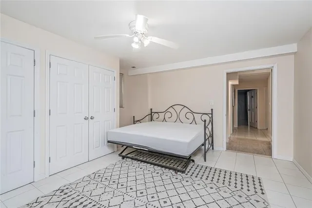 a bedroom with two beds and a chandelier