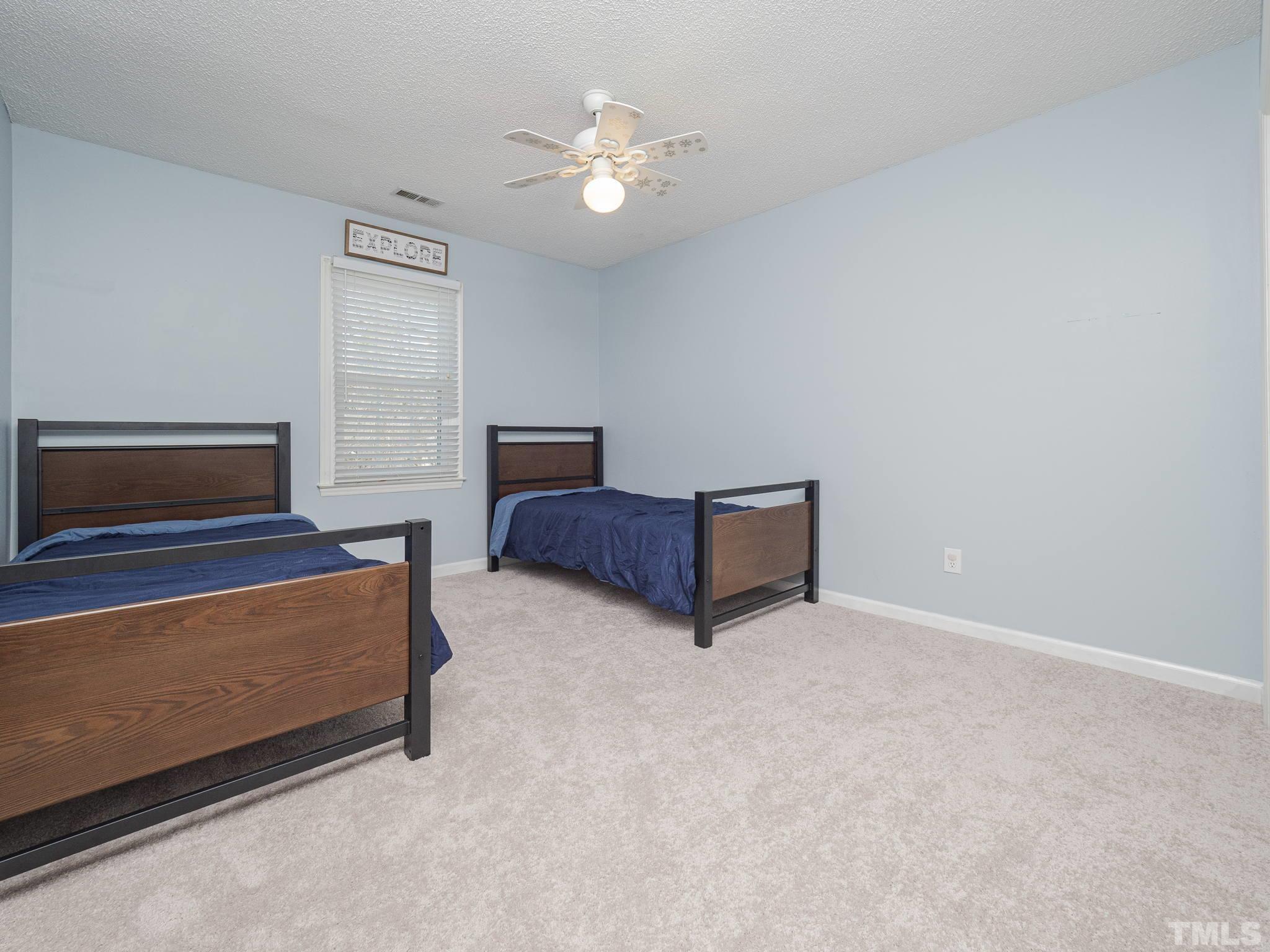 11233 North Radner Way Raleigh, NC 27613 - Photo 10 of 15 a living room with furniture and a chandelier