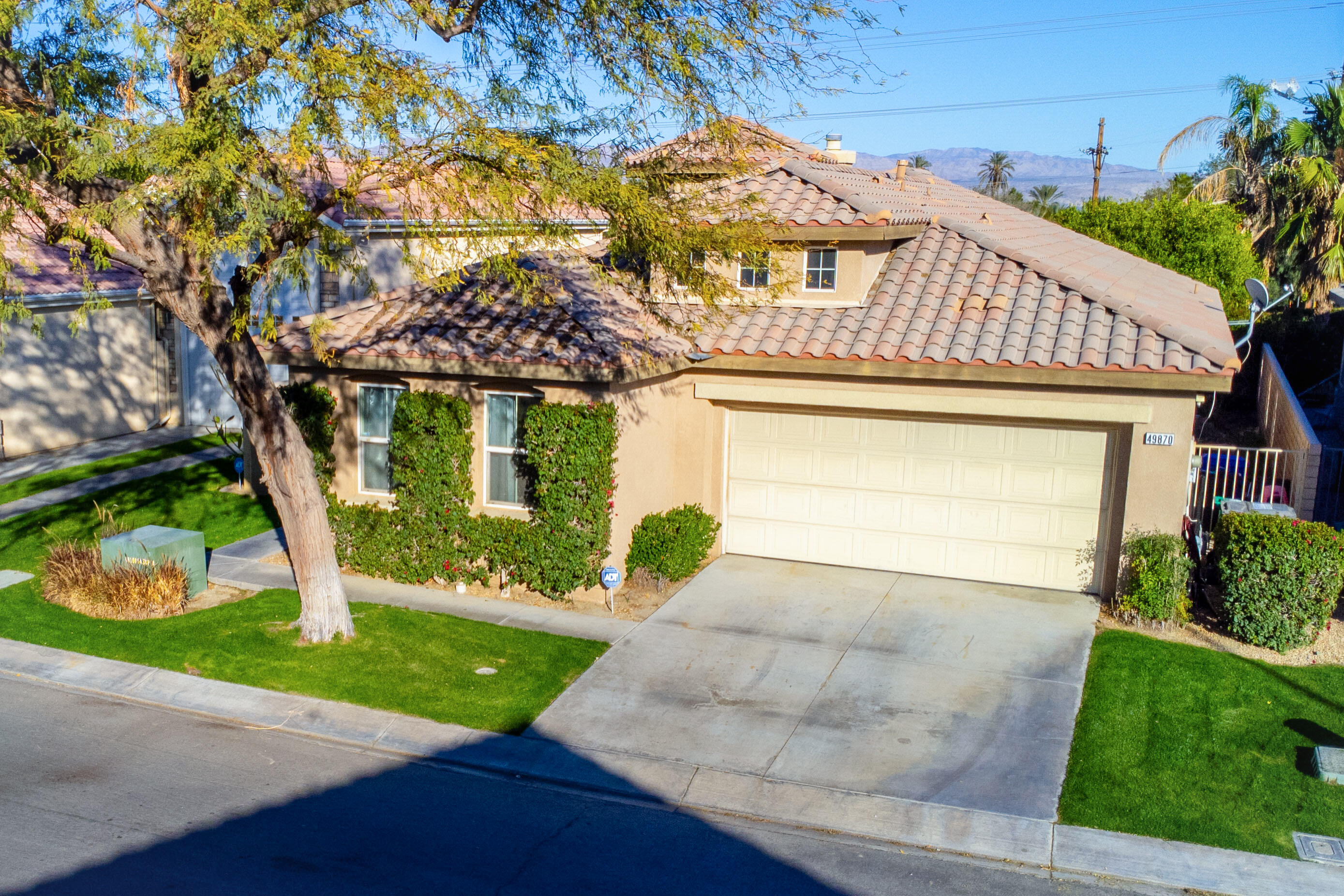 49870 Lewis Road Indio, CA 92201 - Photo 5 of 47 a front view of a house with garden