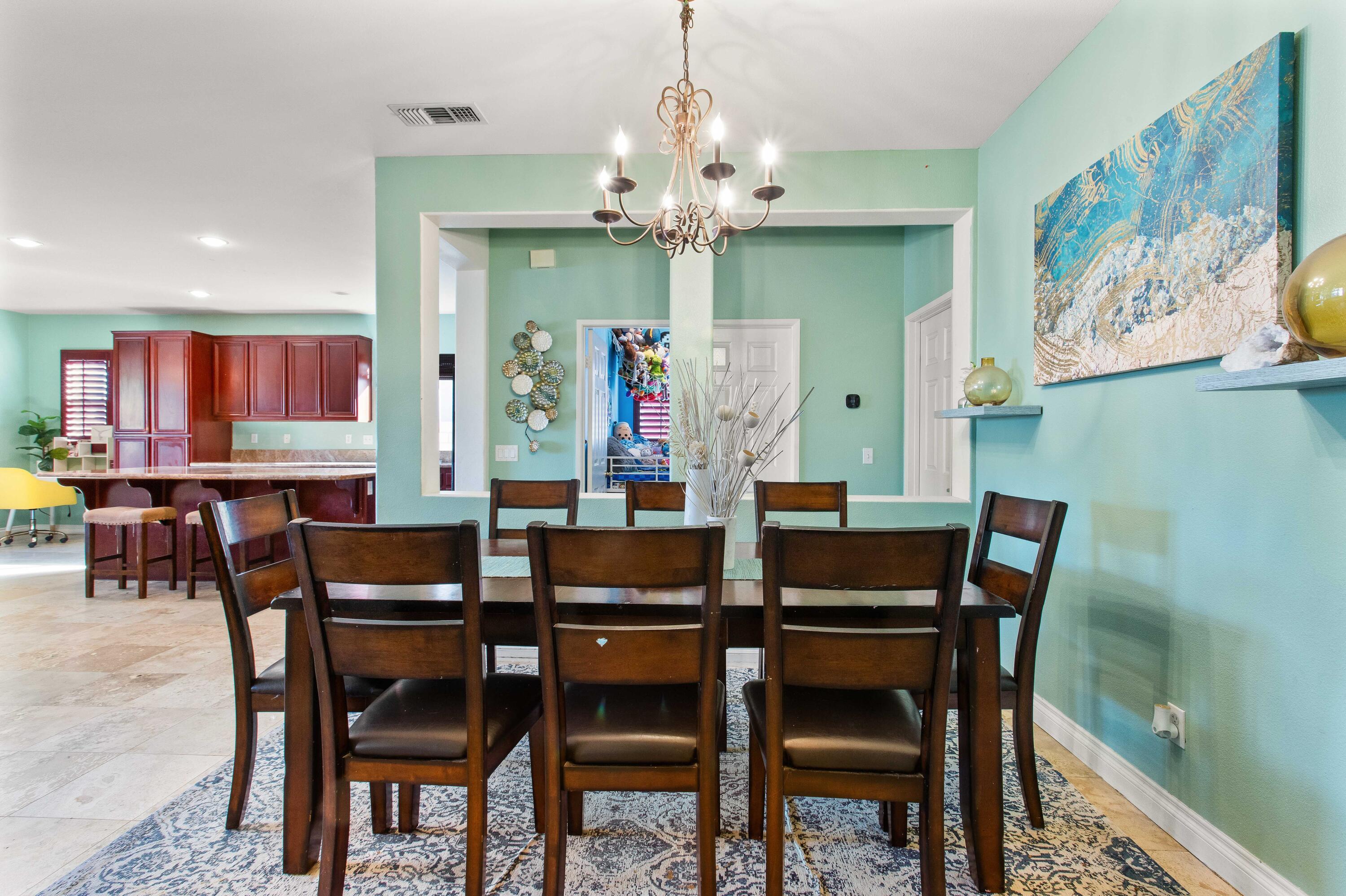 49870 Lewis Road Indio, CA 92201 - Photo 8 of 47 a view of a dining room with furniture and chandelier