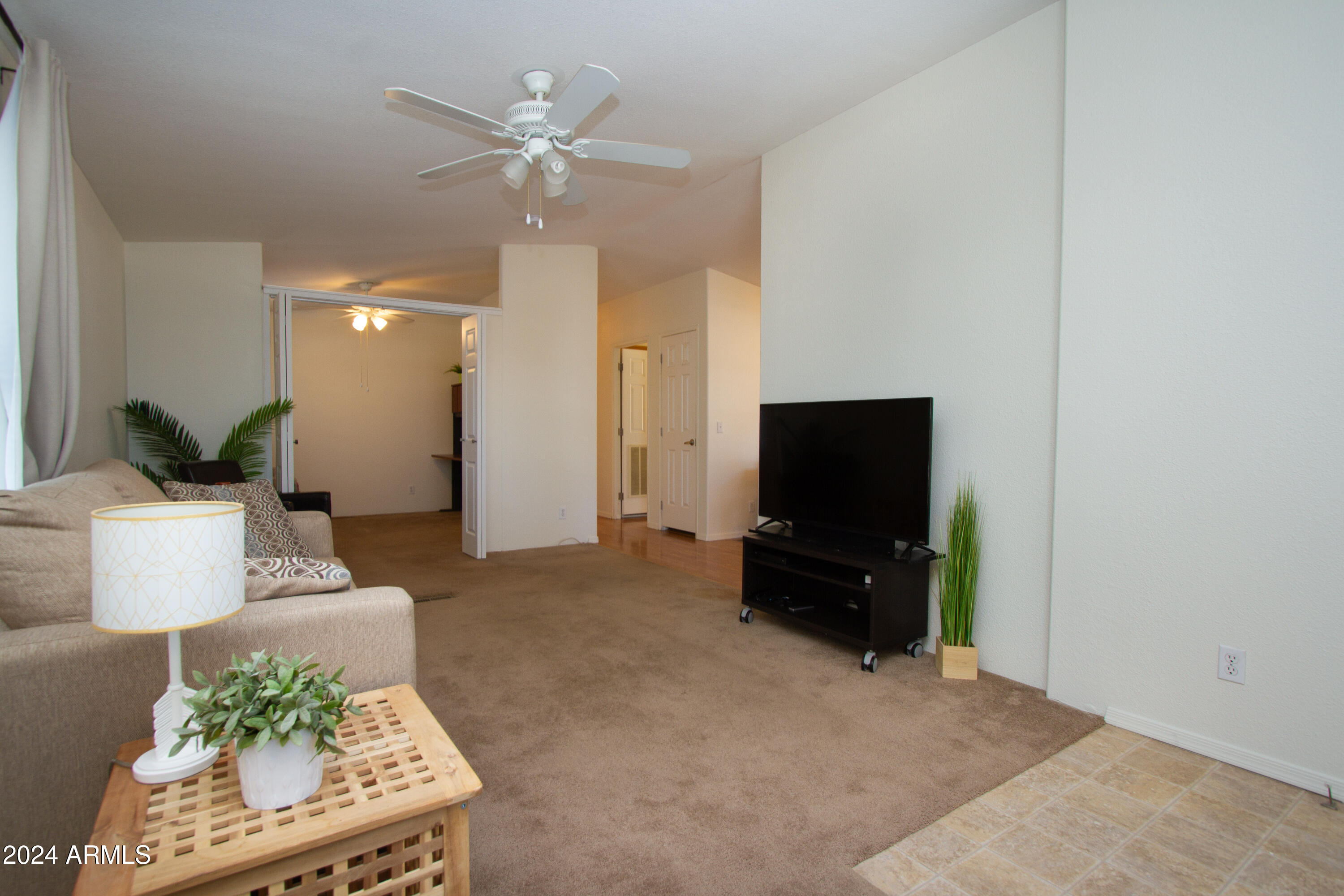 3700 South Tomahawk Road, Unit 93 Apache Junction, AZ 85119 - Photo 11 of 40 a living room with furniture and a flat screen tv