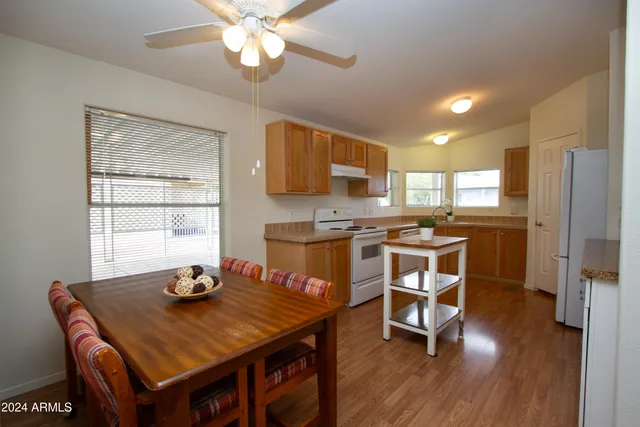 a kitchen with stainless steel appliances granite countertop a stove refrigerator sink and cabinets