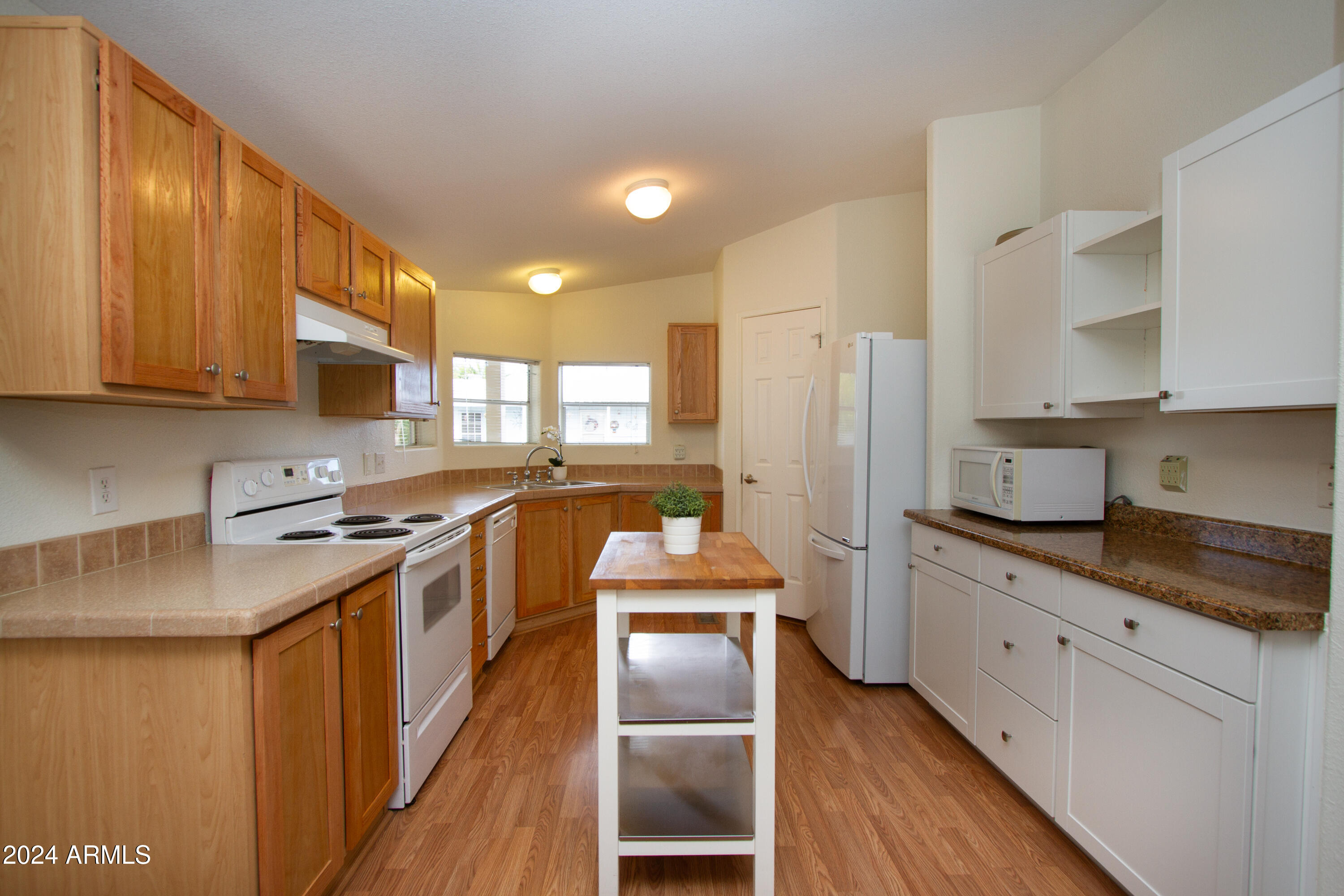 3700 South Tomahawk Road, Unit 93 Apache Junction, AZ 85119 - Photo 17 of 40 a kitchen with stainless steel appliances granite countertop a stove refrigerator sink and cabinets
