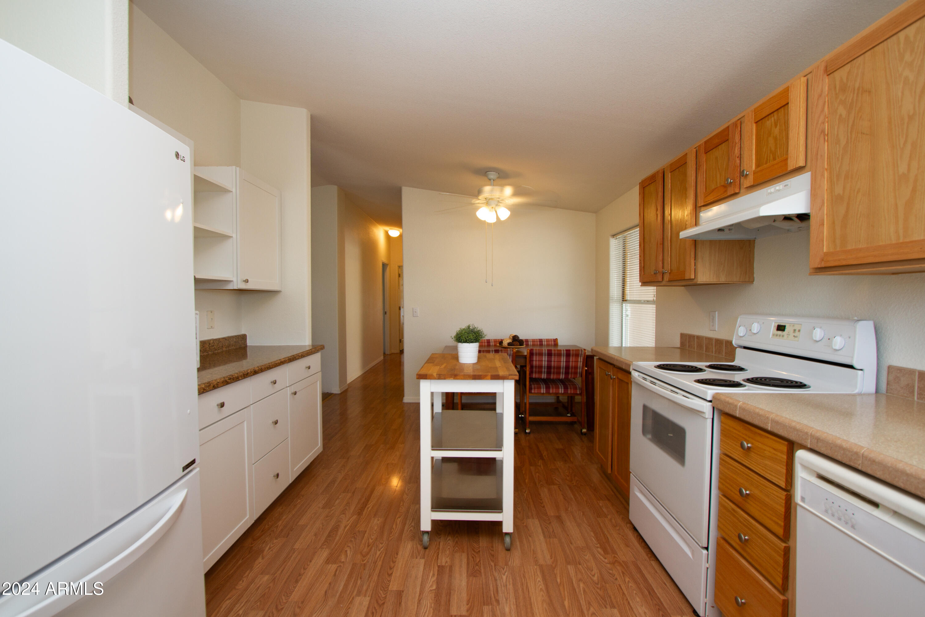 3700 South Tomahawk Road, Unit 93 Apache Junction, AZ 85119 - Photo 20 of 40 a kitchen with a stove a sink and a refrigerator